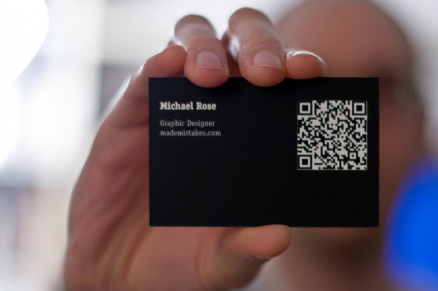 Holding a Made Mistakes business card